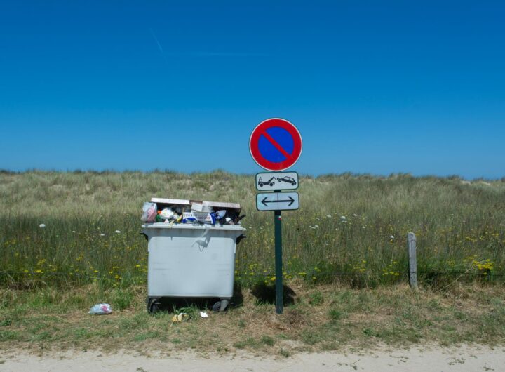 road sign and garbage bin in countryside